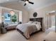 Main bedroom suite featuring water views, vaulted ceilings, window seat, ceiling fan, and a dark wood sleigh bed at 9916 Lone Tree Ln, Orlando, FL 32836