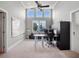 Spacious office featuring a ceiling fan, a large window, and built-in shelving at 9916 Lone Tree Ln, Orlando, FL 32836
