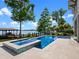 Sparkling pool and spa with a private dock overlooking the serene lake, perfect for recreation at 9916 Lone Tree Ln, Orlando, FL 32836