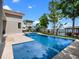 Beautiful pool area with integrated spa, lush landscaping, and picturesque lake views at 9916 Lone Tree Ln, Orlando, FL 32836