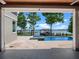 Stunning view from the covered patio to the lake, pool and dock, on a bright sunny day at 9916 Lone Tree Ln, Orlando, FL 32836
