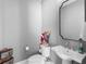 Stylish powder room featuring a pedestal sink, classic fixtures, and decorative accents at 9916 Lone Tree Ln, Orlando, FL 32836