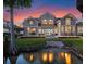 Beautiful backyard featuring a patio, and waterfront at sunset, providing serene outdoor living at 9916 Lone Tree Ln, Orlando, FL 32836