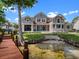 Beautiful rear exterior featuring a private waterfront, patio, and inviting outdoor space at 9916 Lone Tree Ln, Orlando, FL 32836