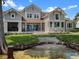 Stunning rear exterior featuring a spacious patio and gradual steps down to a private waterfront at 9916 Lone Tree Ln, Orlando, FL 32836