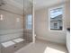 Bathroom shower features tiled walls, a tiled inlay accent, and glass door at 9916 Lone Tree Ln, Orlando, FL 32836