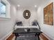Cozy sitting area with comfortable seating, decorative mirror, dark table and an area rug on hardwood floors at 9916 Lone Tree Ln, Orlando, FL 32836