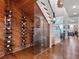 Modern wine cellar with a glass enclosure adjacent to the main living space with wood floors at 9916 Lone Tree Ln, Orlando, FL 32836