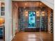 Modern wine cellar behind glass walls showcases stone accent walls and wooden wine storage at 9916 Lone Tree Ln, Orlando, FL 32836