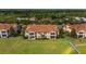 Beautiful aerial shot showcasing the community homes with red tile roofs surrounded by lush greenery at 10371 Kensington Shore Dr # H-201, Orlando, FL 32827