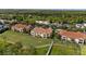 Wide aerial view of the community homes surrounded by trees and foliage at 10371 Kensington Shore Dr # H-201, Orlando, FL 32827
