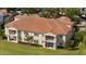 Scenic aerial view of community homes featuring private balconies with outdoor seating and lush green landscaping at 10371 Kensington Shore Dr # H-201, Orlando, FL 32827
