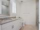 Neutral bathroom featuring granite countertop, under mount sink and glass enclosed shower at 10371 Kensington Shore Dr # H-201, Orlando, FL 32827