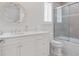Elegant bathroom featuring a modern vanity, decorative mirror, and a glass-enclosed shower with decorative tile at 10371 Kensington Shore Dr # H-201, Orlando, FL 32827