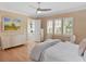 Bright bedroom features wood floors, white furniture, and lots of natural light at 10371 Kensington Shore Dr # H-201, Orlando, FL 32827