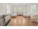 Bright bedroom with twin beds, light wood floors, white walls, and natural light from window shutters at 10371 Kensington Shore Dr # H-201, Orlando, FL 32827