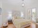 Bright bedroom featuring a queen bed, wood floors, and french doors to balcony at 10371 Kensington Shore Dr # H-201, Orlando, FL 32827