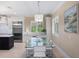 Bright dining area features modern table, chairs, and stylish light fixture for elegant Gathering dining at 10371 Kensington Shore Dr # H-201, Orlando, FL 32827