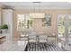 Bright dining area features modern table, chairs, and stylish light fixture for elegant Gathering dining at 10371 Kensington Shore Dr # H-201, Orlando, FL 32827