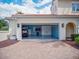 Garage exterior featuring a brick paver driveway and colorful wall accents at 10371 Kensington Shore Dr # H-201, Orlando, FL 32827