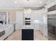 Stylish kitchen with white cabinetry, a black island, and modern stainless steel appliances at 10371 Kensington Shore Dr # H-201, Orlando, FL 32827