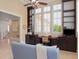 Bright office featuring custom built-in shelving, desk, and large picture windows at 10371 Kensington Shore Dr # H-201, Orlando, FL 32827