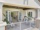 Outdoor patio shows comfortable seating and views through shuttered doors to the home's interior at 10371 Kensington Shore Dr # H-201, Orlando, FL 32827