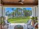 Covered patio provides an idyllic outdoor retreat with views of expansive green spaces and water at 10371 Kensington Shore Dr # H-201, Orlando, FL 32827
