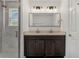 Modern bathroom features a double vanity with dark cabinets and a glass-enclosed shower at 1040 20Th St, Orlando, FL 32805