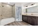Bright bathroom with modern fixtures, double vanity, a glass enclosed shower and a tub at 1040 20Th St, Orlando, FL 32805