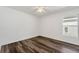 A well-lit bedroom has wood-look floors, a window, and a ceiling fan at 1040 20Th St, Orlando, FL 32805