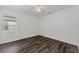A well-lit bedroom has wood-look floors, a window, and white walls at 1040 20Th St, Orlando, FL 32805