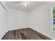 Bright bedroom with wood-look flooring, ceiling fan, closet and window at 1040 20Th St, Orlando, FL 32805