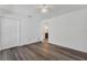 A well-lit bedroom with wood-look floors, a ceiling fan, and a closet at 1040 20Th St, Orlando, FL 32805