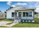 Attractive home with a covered front porch, updated grey trim, and beautiful curb appeal at 1040 20Th St, Orlando, FL 32805
