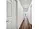 A long hallway features wood-look floors, white walls, and recessed lighting at 1040 20Th St, Orlando, FL 32805