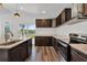 Kitchen featuring a breakfast bar, dark cabinets, and stainless steel appliances at 1040 20Th St, Orlando, FL 32805