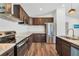 Kitchen featuring dark cabinets, stainless steel appliances, and hardwood flooring at 1040 20Th St, Orlando, FL 32805