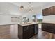 Modern kitchen features a spacious island, stainless steel appliances, and a large window overlooking the lake at 1040 20Th St, Orlando, FL 32805