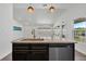 Kitchen island features a stainless steel dishwasher, sink with faucet, and barstool seating at 1040 20Th St, Orlando, FL 32805