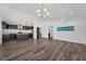 Open-concept living area boasts luxury vinyl plank floors, stylish lighting, and easy flow to kitchen at 1040 20Th St, Orlando, FL 32805