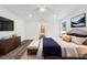 A well-lit main bedroom with wood-look floors, ensuite bath, and modern decor at 1040 20Th St, Orlando, FL 32805
