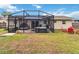 Inviting screened-in lanai featuring a jacuzzi, patio seating, and lush lawn, perfect for relaxation and entertaining at 10934 Tangora St, Orlando, FL 32825