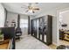A clean bedroom with a ceiling fan, large closet, and a window with natural light at 10934 Tangora St, Orlando, FL 32825
