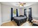 Comfortable bedroom with a ceiling fan, a window, an adjacent workstation, and tile flooring at 10934 Tangora St, Orlando, FL 32825
