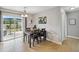 Bright dining area with tile flooring, stylish table, and sliding glass doors to an outdoor space at 10934 Tangora St, Orlando, FL 32825
