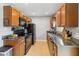 Functional kitchen featuring granite countertops, stainless steel appliances, and ample cabinetry for storage and organization at 10934 Tangora St, Orlando, FL 32825