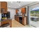 Galley kitchen with dark cabinets, granite counters, black appliances, and easy access to a hot tub at 10934 Tangora St, Orlando, FL 32825