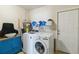 This is a clean and organized laundry room with a sink, washer, and dryer at 10934 Tangora St, Orlando, FL 32825