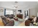 Spacious living room with tile floors, comfortable seating, and a view into the bedroom at 10934 Tangora St, Orlando, FL 32825